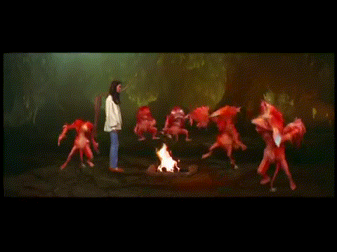 Sarah meets the Fire Gang, a group of fuzzy orange fire demons. They take off their heads and throw them while dancing around a campfire.