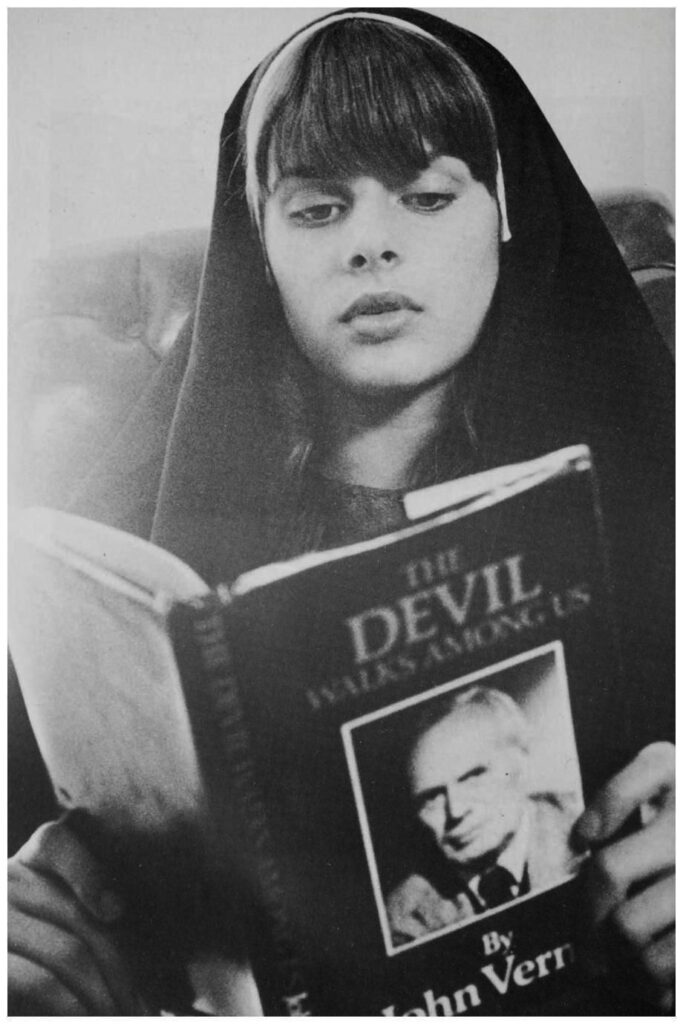 A young nun reading a book titled "The Devil Walks Among Us".